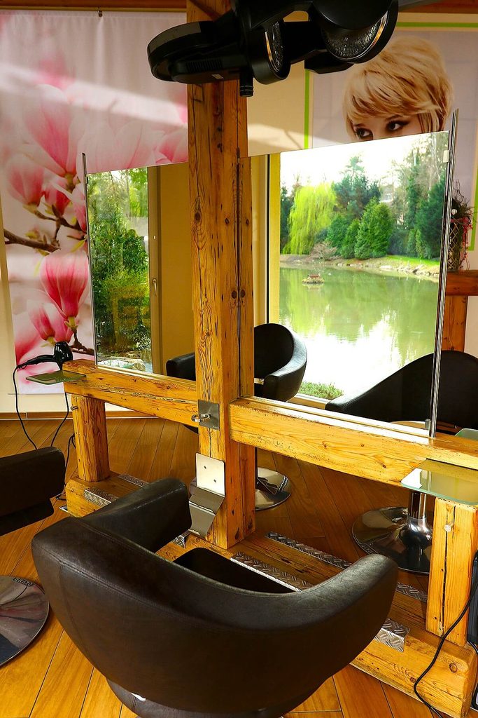 Friseurstuhl im Salon Zeit fürs Haar in Zirndorf / Weiherhof mit Spiegelblick auf den Weiher im Hintergrund